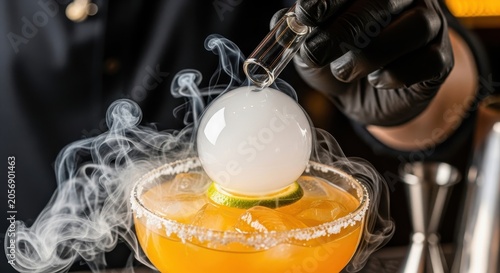 Bartender preparing a smoky cocktail with a spherical bubble garnish.