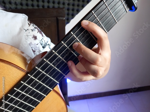 A close up of guitar chord with white and blue background