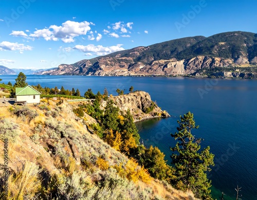 Scenic coastal landscape with rocky cliffs and clear blue water.
