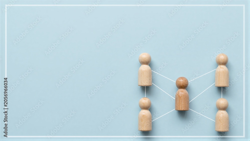 Obraz premium Wooden figures connected by lines, symbolizing teamwork or collaboration.