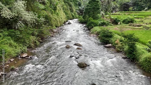 Low Altitude Drone Flight Above Tropical River and Jungle Valley in Indonesia