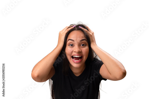 Excited young latina woman holding head in disbelief isolated on white background.