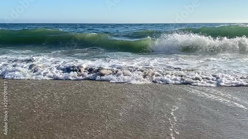 Slow motion of an ocean wave rolling onto the beach
