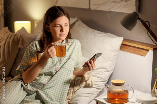 Young woman relaxing in bed...