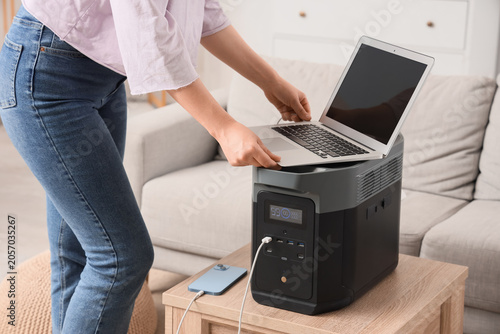 Woman connecting laptop to ...