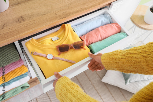 Woman organizing clothes in...