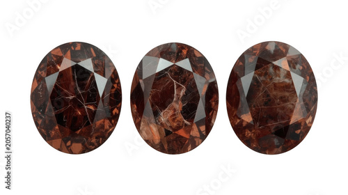 Garnet crystals are arranged in an elegant row of three, featuring distinct oval cuts and rich, dark red tones that highlight the exquisite craftsmanship required for fine jewelry design.