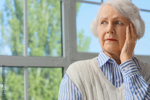 Thoughtful senior woman wit...