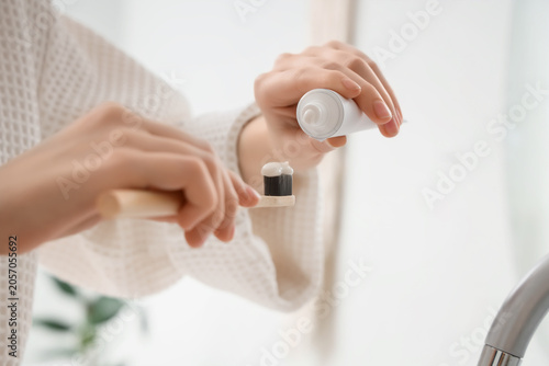 Person squeezing toothpaste...