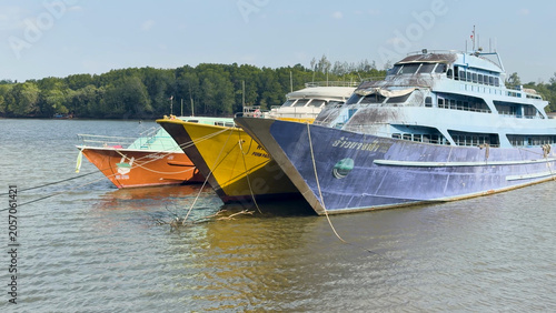 Fotografía Colorful Passenger Ferries Docked on a River in Krabi Thailand