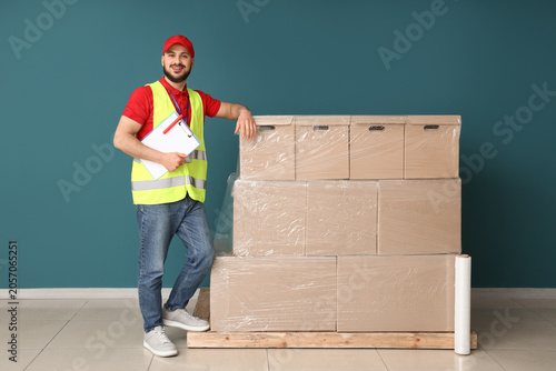 Smiling delivery man in saf...
