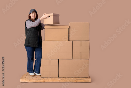 Young woman courier stackin...