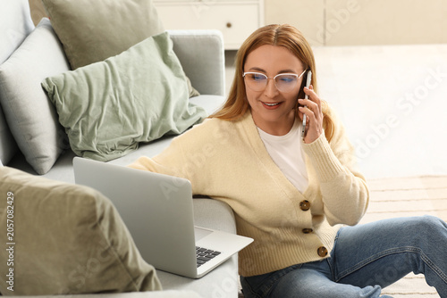 Smiling woman in glasses ta...