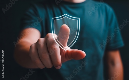 Hand touching shield icon for security protection and safety.