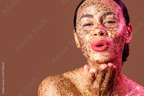 Young woman covered in gold...
