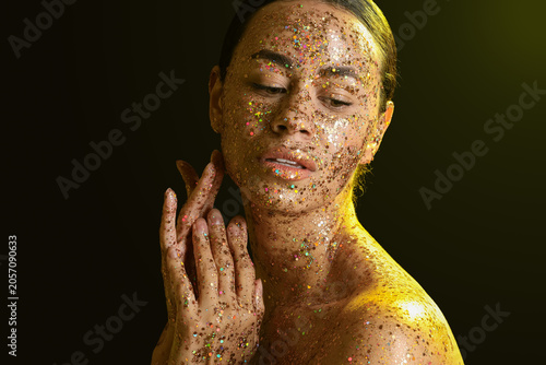 Young woman with glitter ma...