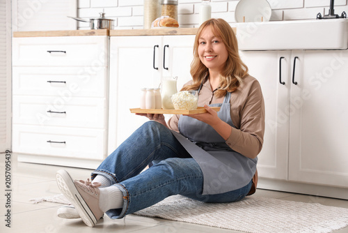 Smiling woman in apron hold...