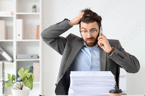 Stressed businessman on pho...