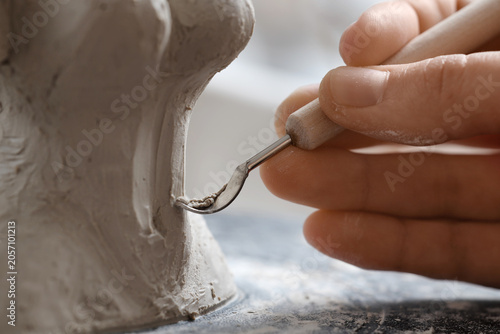 Hand of female sculptor wit...