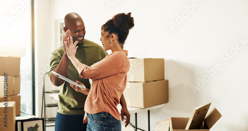 Quadro su tela Happy, couple and high five in new home with tablet, bonding or complete interior design planning