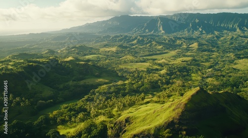 Expansive Green Mountain Ranges Under Bright Daylight Showcasing Intricate Landscapes From Aerial View