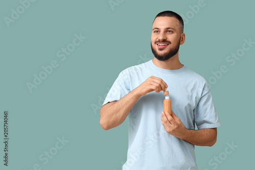 Happy young man with bottle...