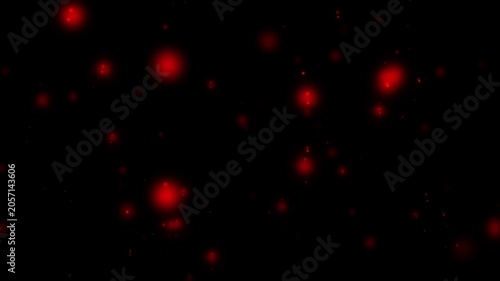 Red glowing particles on a dark background creating a cosmic effect