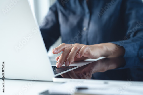 Photography Close up, business woman working on laptop computer, surfing the internet, searching the information with digital tablet on table office