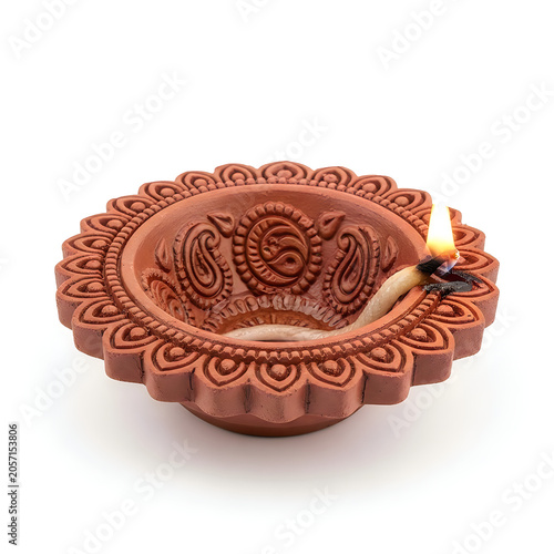 Decorative diya with intricate design and flame