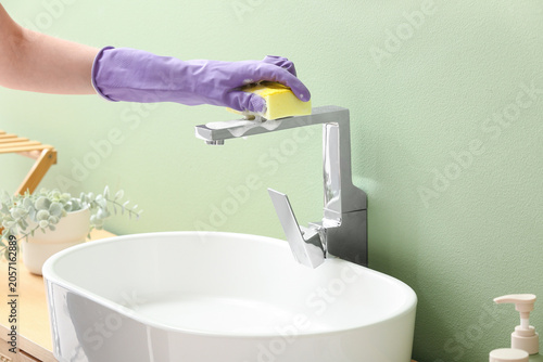 Hand in purple glove cleani...