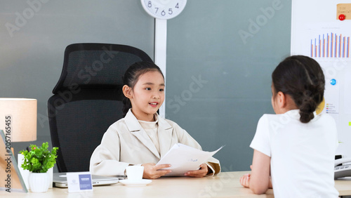 Valokuva Young Asian Girl in White Blazer Roleplaying as Businesswoman in Office