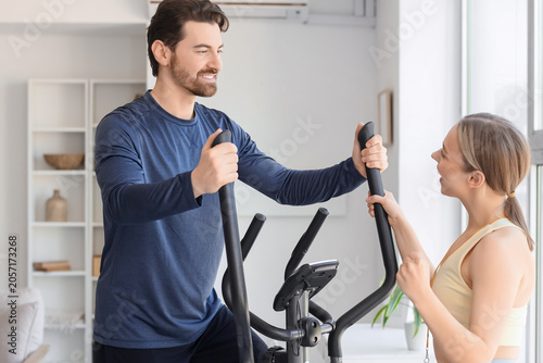 Happy couple exercising tog...