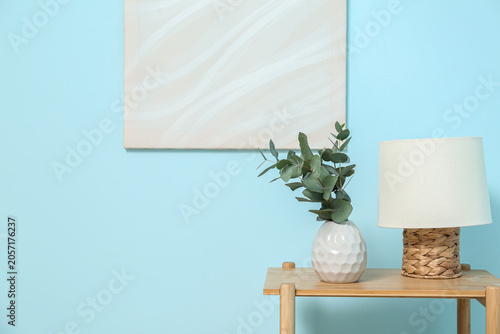 Lamp and vase with eucalypt...
