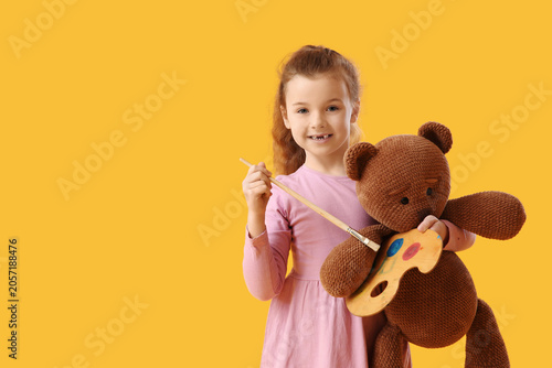 Smiling little girl holding...