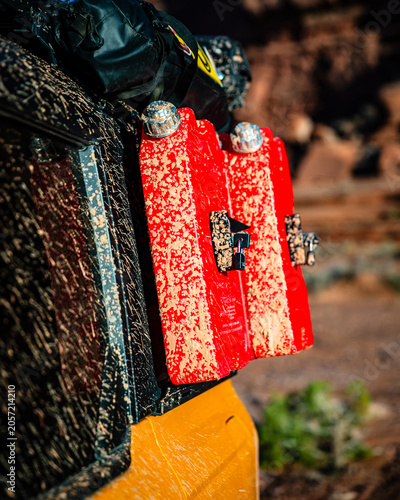 Muddy red fuel containers on an offroad vehicle