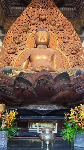 Vertical tilting shot of a Buddha statue inside Byodo-In Temple