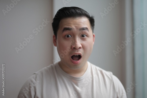Bild auf Leinwand Young man with a shocked facial expression