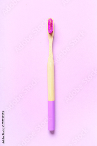 Wooden toothbrush on purple...