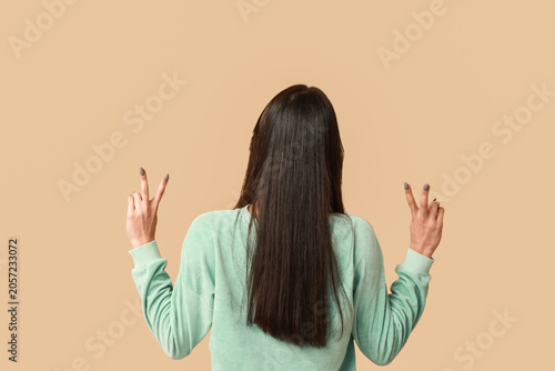Young woman showing peace s...