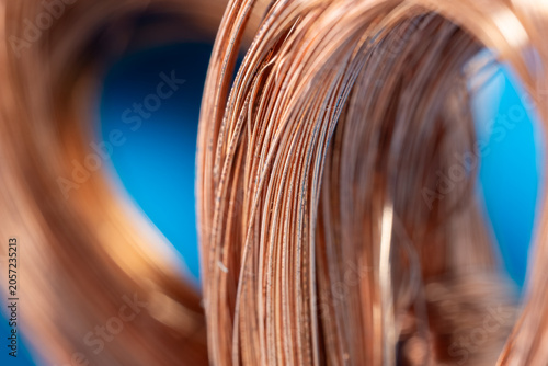 Macro shot of raw copper wires roll. Premium metallic background for energy, power, electricity, and hardware business. Clean professional industry image for stock supply.