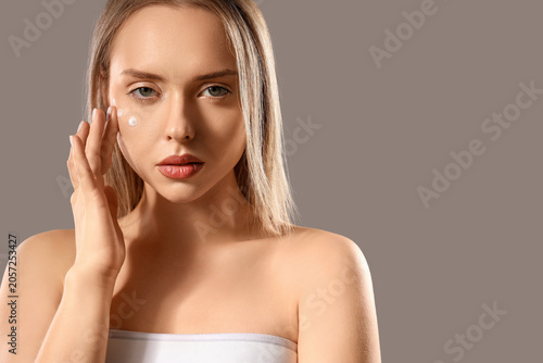 Sexy young woman with cream...