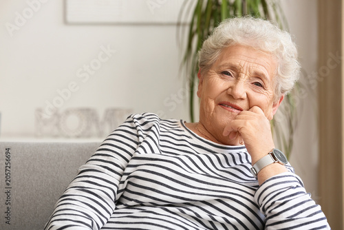 Senior woman resting on sof...