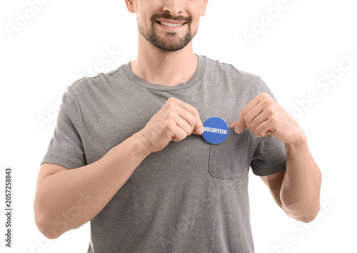 Male volunteer with badge o...