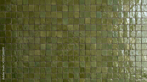Green Tile Texture: A detailed close-up showcases the subtle variations and reflective sheen of numerous small, square green tiles, creating a visually rich surface texture.