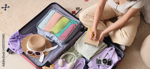 Young woman with suitcase w...