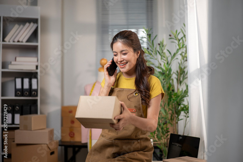 Woman entrepreneur talking on phone with customer