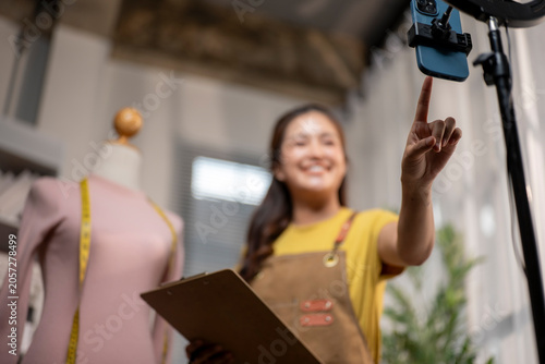 Asian designer influencing live streaming from her small business