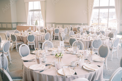 Фотография Elegant wedding reception banquet hall with round tables
