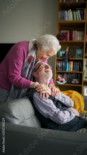 Elderly partners relaxing on sofa after sunday lunch.