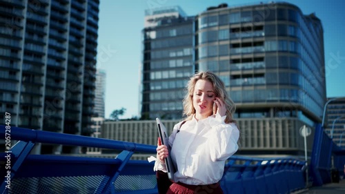 Businesswoman talking on smartphone in financial district.